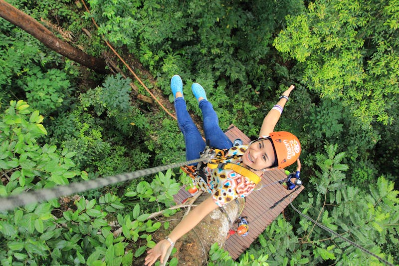 a woman enjoying a kona zip line
